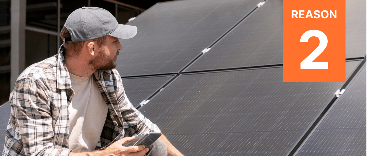 A homeowner gazes at his solar panels, evaluating the manufacturer warranty